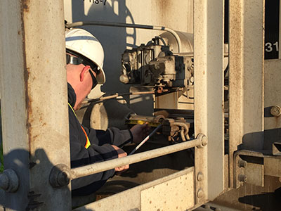 Staff inspecting rail car piston