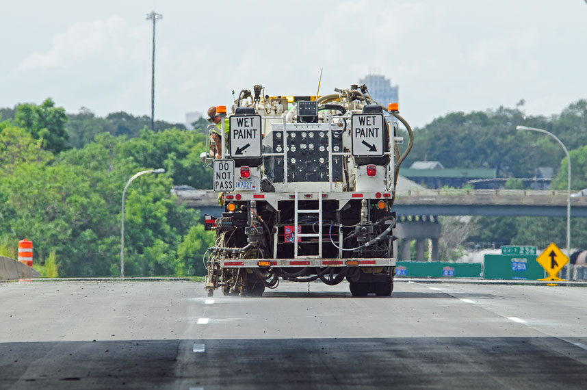 Pavement marking truck applying new markings