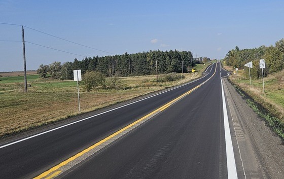 Hwy 25 north of Pierz showing road open and complete in a farm area